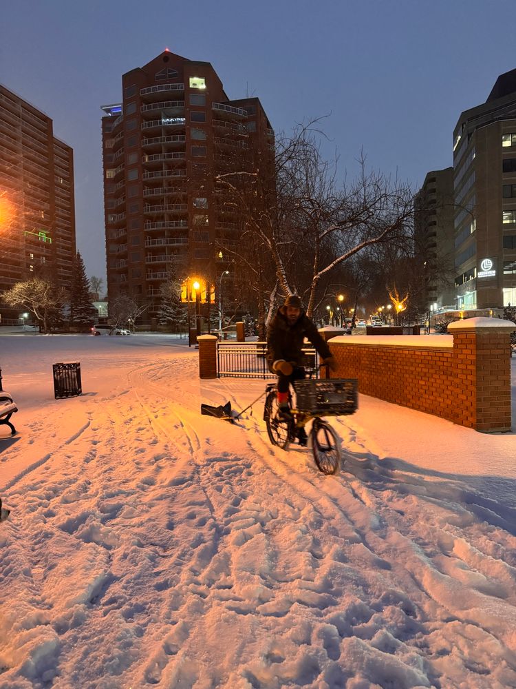 Bike plough inventer Keith arriving towing his creation 
