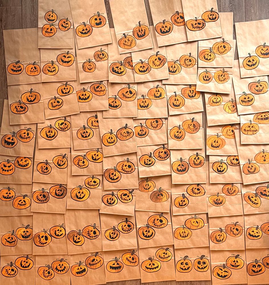 62 paper bags decorated with Halloween pumpkins