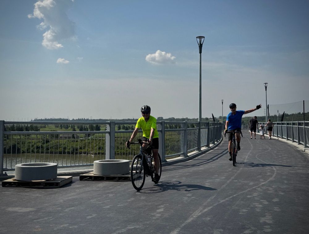 Happy cyclists crossing new bridge 