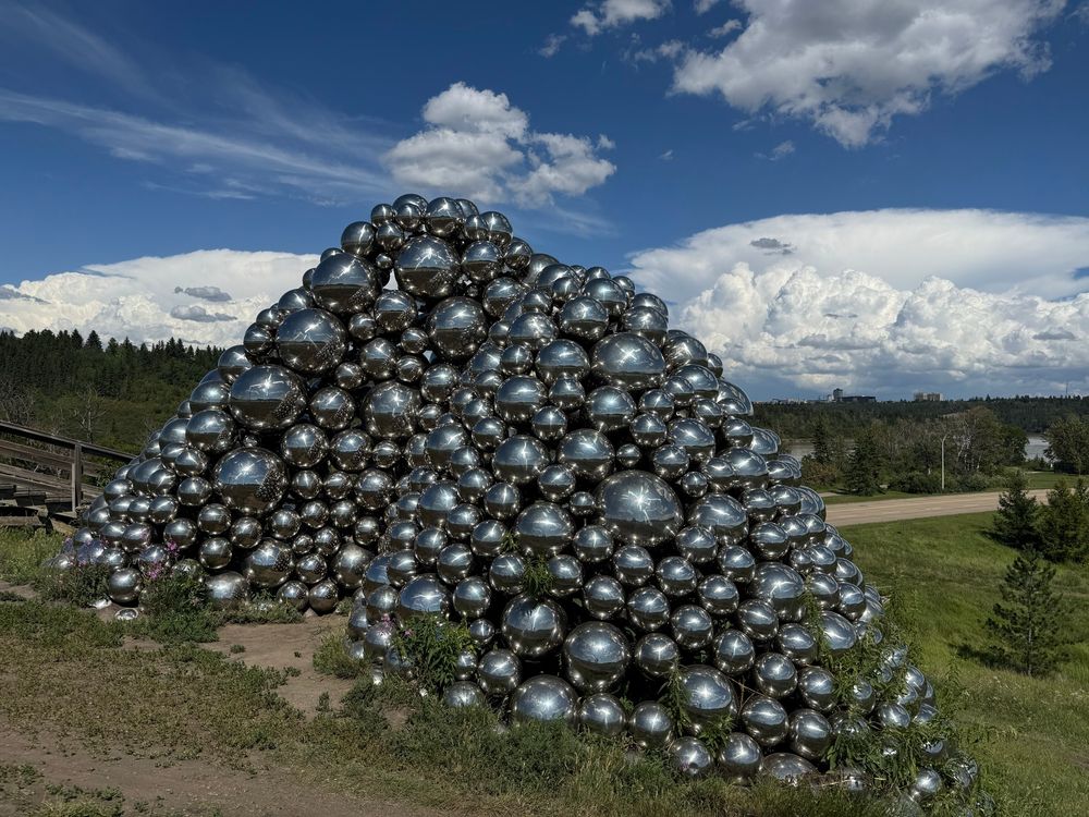 Talus Balls sculpture with cool clouds overhead 