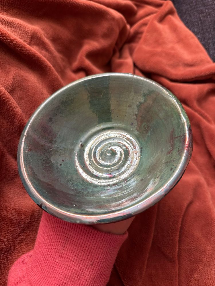 Raku firing of a bowl with blue moon glaze