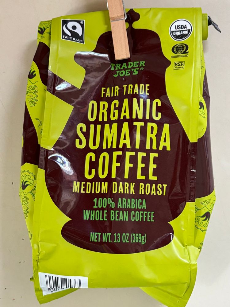 a 13 ounce bag of sumatran coffee has a strong resemblance to the cover of the book i just posted, a dark coffee pot shape over a mossy green background.