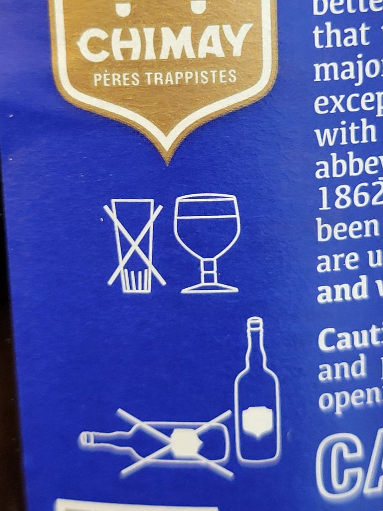 Label on the side of a Chimay beer bottle with a crossed out regular shaped glass, and a goblet glass. 