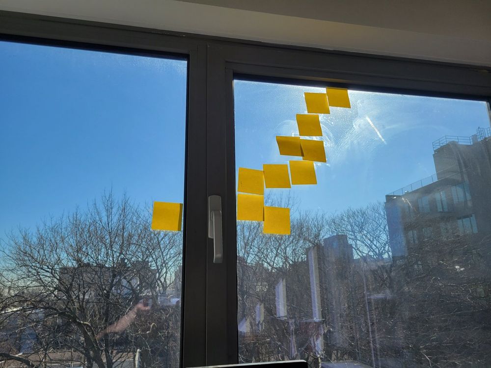 A series of sticky notes on the window that follows the path of the sun 
