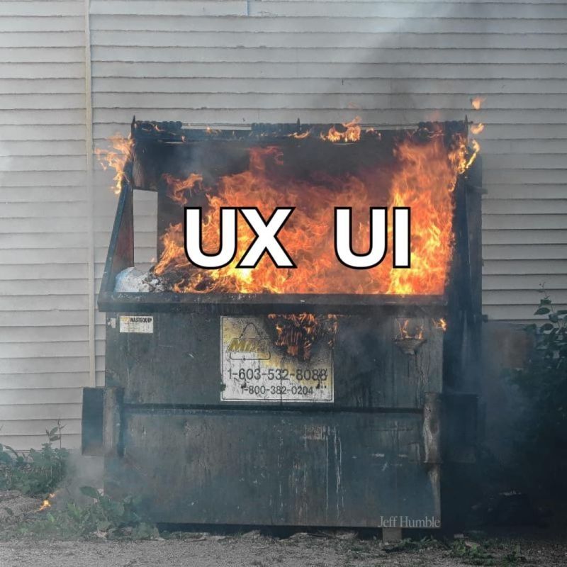A burning dumpster labeled UX on one side and UI on the other side 