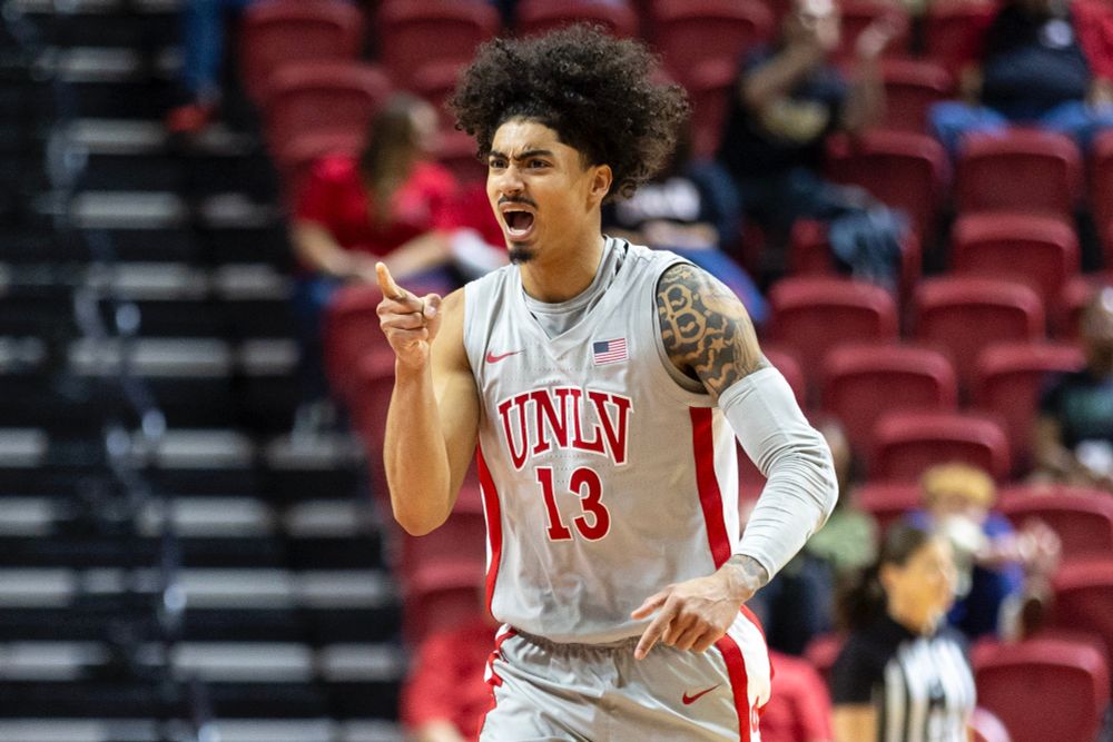 UNLV guard Brooklyn Hicks (13) cheers and points toward his team bench.