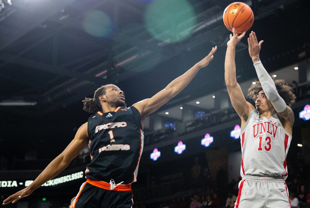 UNLV guard Brooklyn Hicks (13) attempts a three-point shot over Pacific Tigers guard Lamar Washington (1).