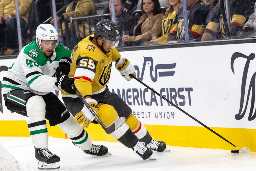 Golden Knights right wing Keegan Kolesar (55) keeps the puck from Dallas Stars defenseman Ilya Lyubushkin (46).
