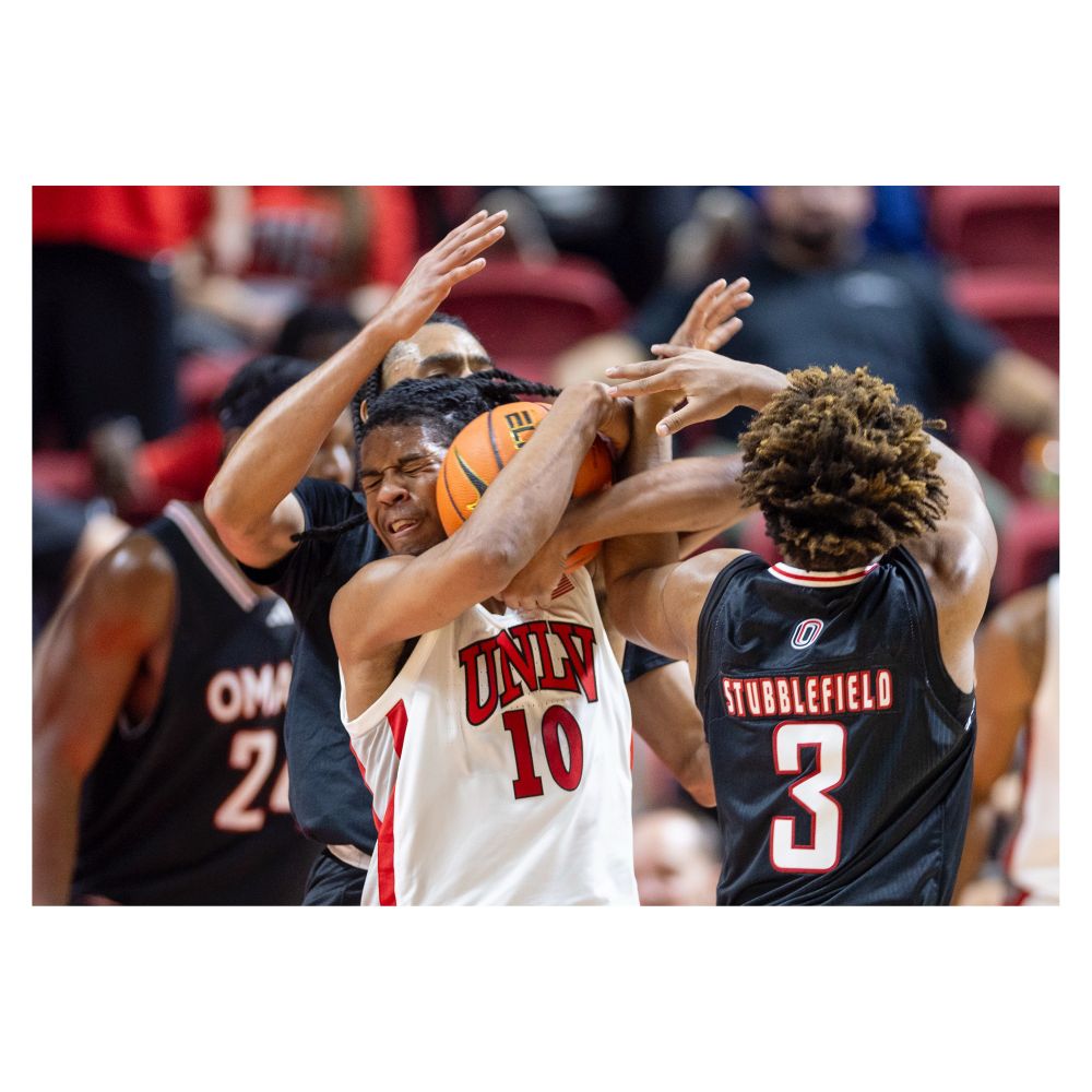 UNLV guard Jaden Henley (10) is surrounded by Omaha Mavericks players.