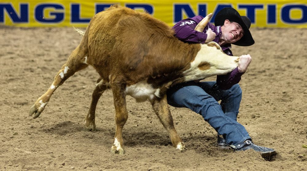 Dalton Massey competes in the steer wrestling event.