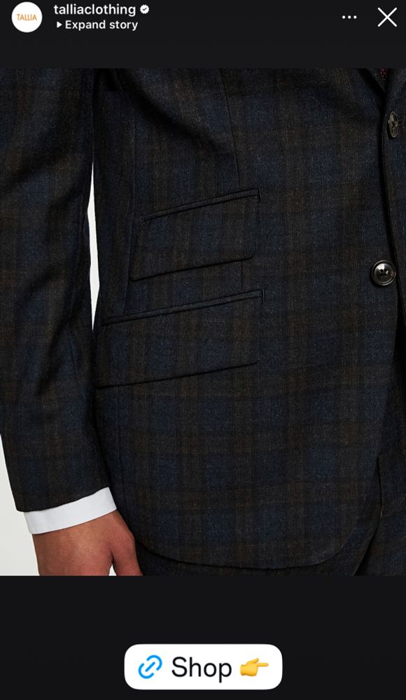 Model wearing a suit that is too small. 