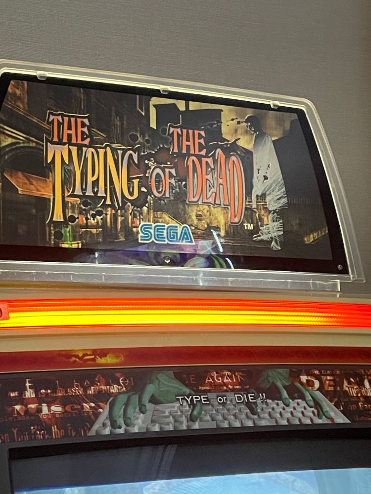 The Typing of the Dead logo on top of an arcade cabinet.