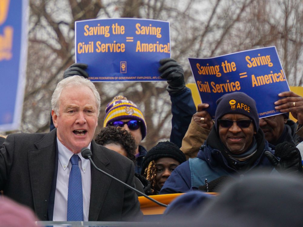 Senator Chris Van Hollen speaking at the AFGE rally on Feb 11th. Background signs read "Saving the Civil Service = Saving America!"