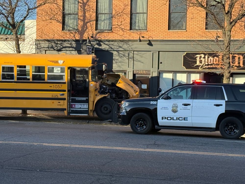 Another angle of the wrecked bus, with an MPD cruiser in front