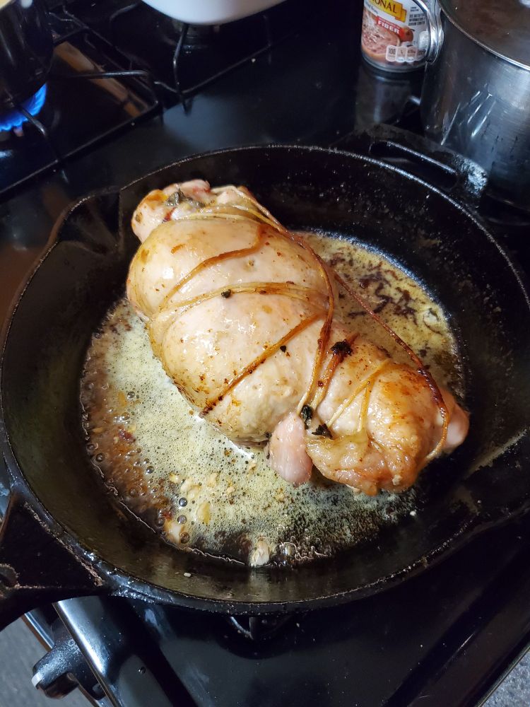 A cooking turkey porchetta