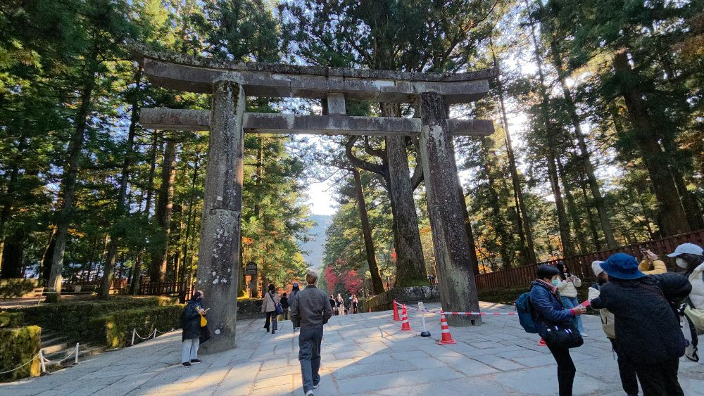 Sightseeing in Nikko, Japan, showing a wooden gate in front of a temple