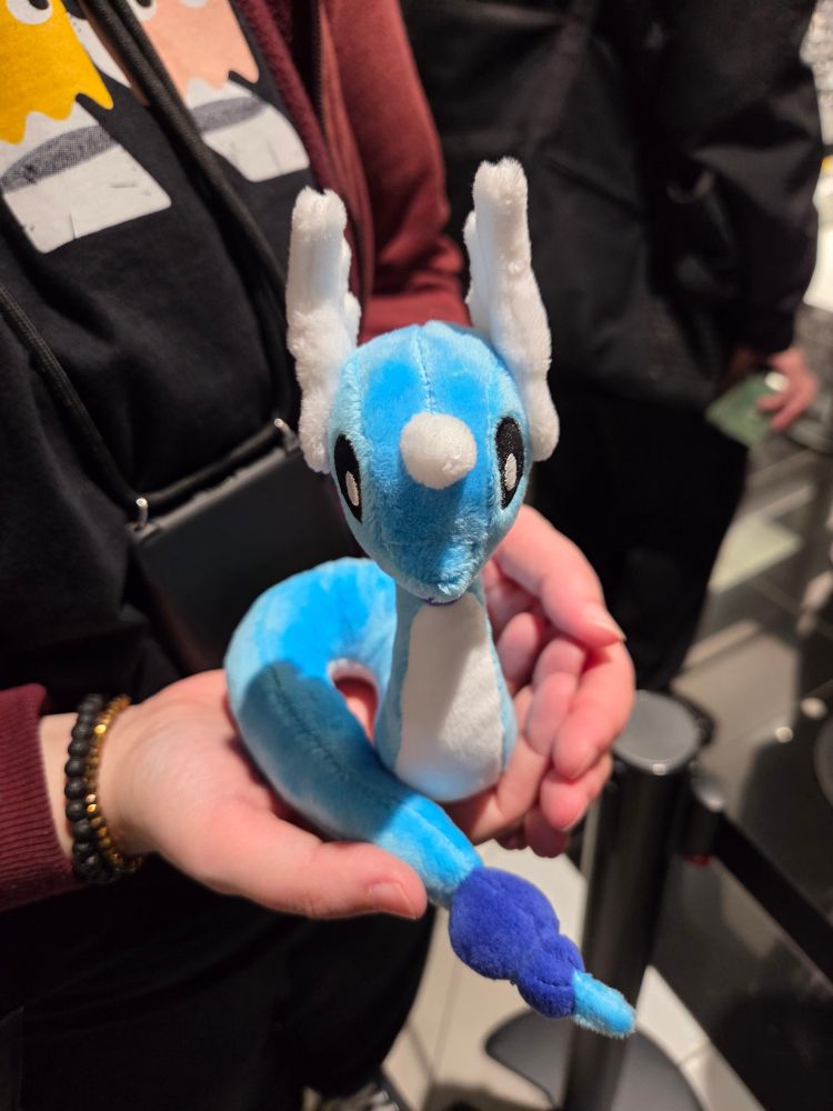 Mel holding a small Dragonair plush