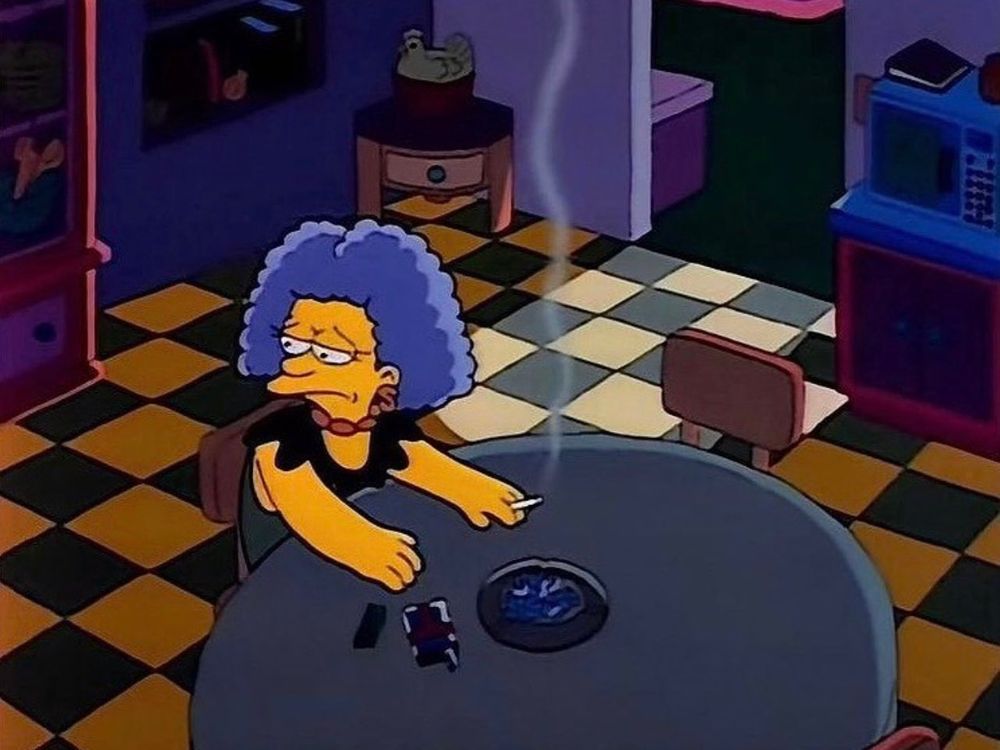 selma smoking alone at the dinner table of the simpsons household kitchen.