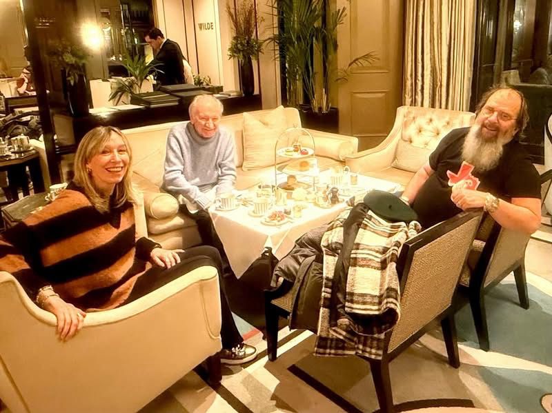 In a lovely tea room bathed in soft golden light, three musicians sit around a low table covered in teacups and plates of cakes and little sandwiches. They are all smiling, properly buzzed on sugar and caffeine 💚