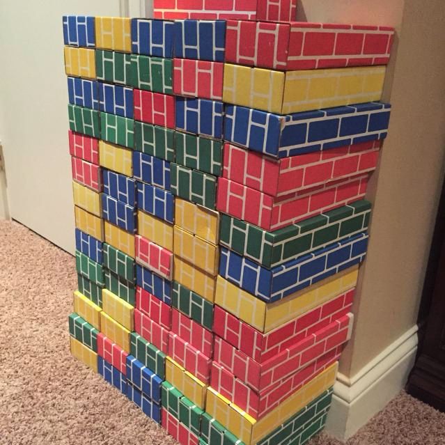 colorful cardboard building bricks stacked up against a wall