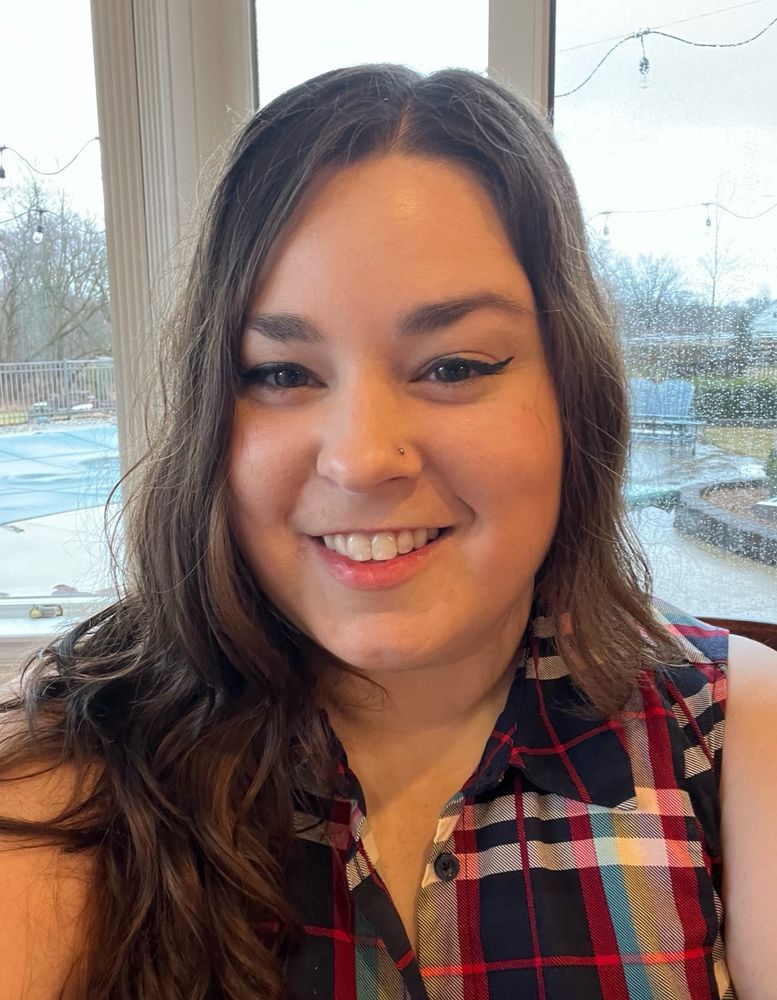 Picture of dark haired girl in plaid shirt