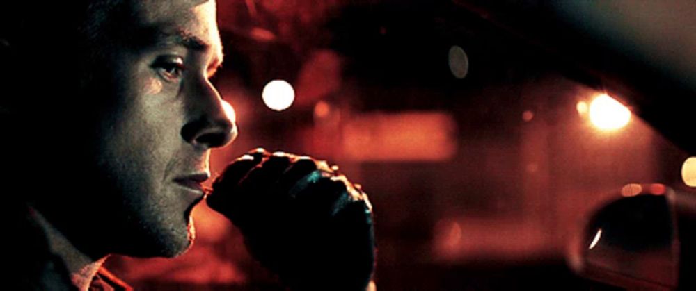 a close up of a man 's face looking out of a car window