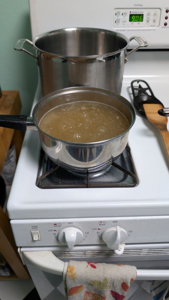 Turkey stock simmering on a stovetop