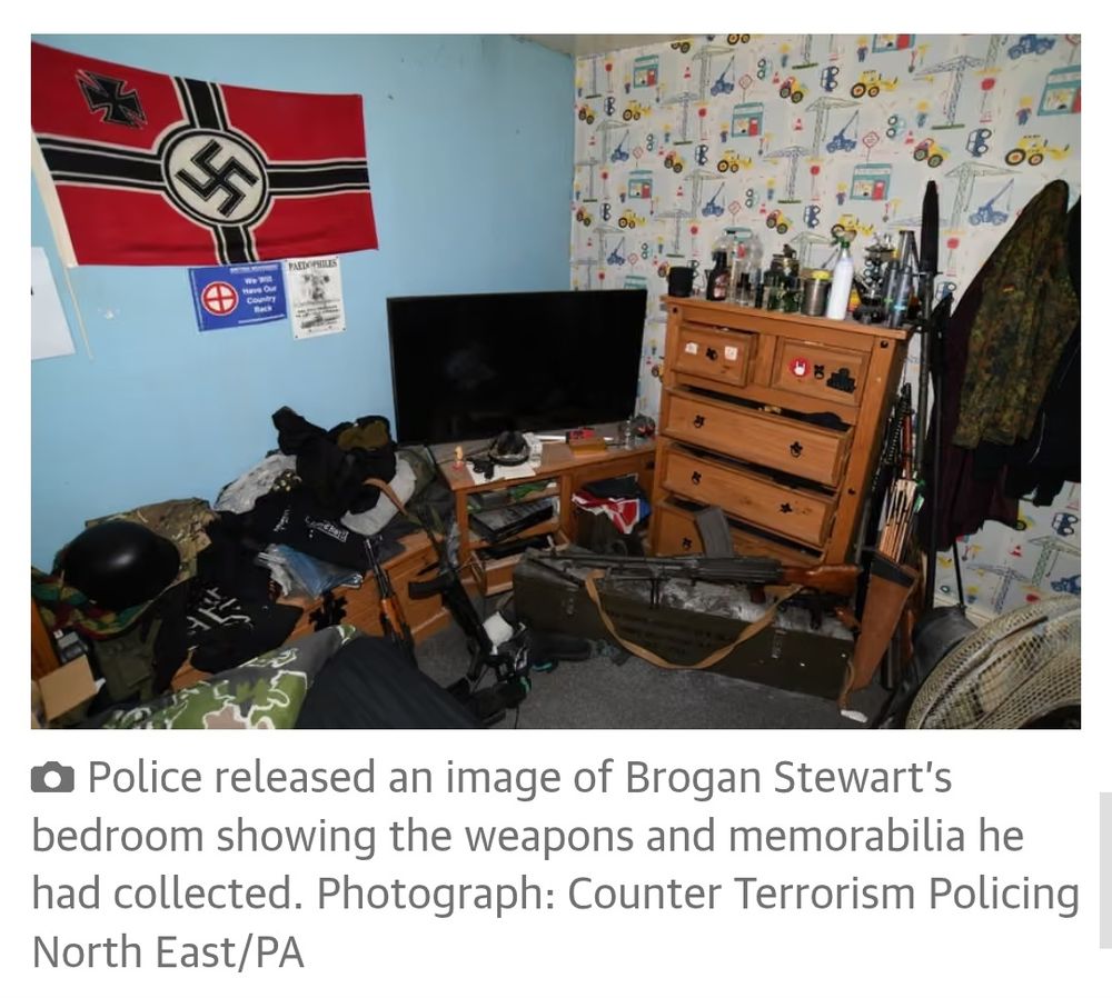 A police photo of a neonazi's bedroom. The floor is a jumble of clothes and assault rifles. On one wall, a swastika flag. On the other, childish construction site-themed wallpaper.