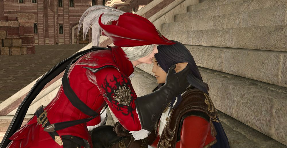 A GPose shot of X’rhun leaning down to kiss Lhaya (who is sitting on a stone stairway) on the forehead. Lhaya is looking quite shocked.