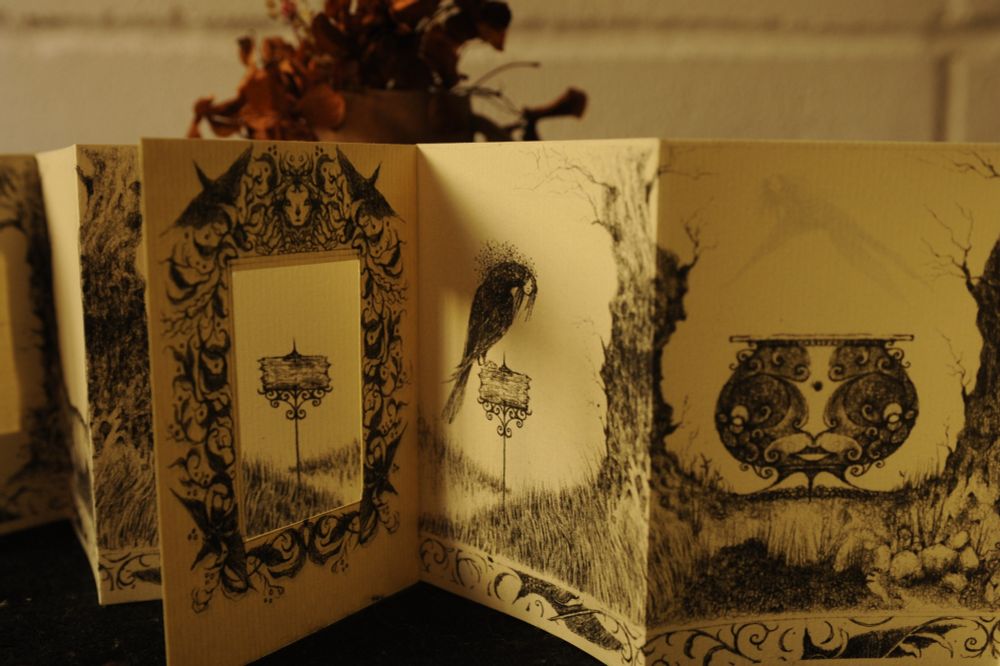 the second half of the zine, now showing the same field but mirrored; instead of empty, we see another crow-witch and a black cauldron with a face carved in its body. through the mirror we look back at the first half, the field empty