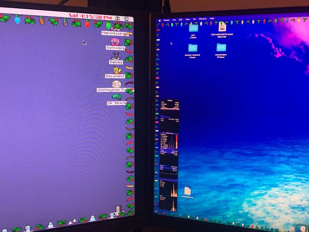 Photograph of two monitors side by side. The one on the left is connected to a Macintosh IIfx, displaying the desktop, with the Holiday Lights app running and creating a border of lights and holly around the desktop. The monitor on the right is connected to a MacBook Pro displaying a modern Mac desktop, with the MacLampsX app running and creating a border of lights and holly around the desktop.