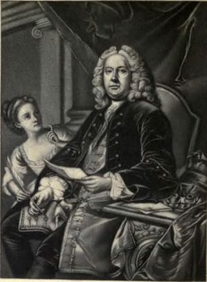 An 18th-century engraving, a portrait of Colley Cibber. He sits in a chair with his left elbow reading on a side table. He holds a paper in his left hand and a quill in his right hand. He wears a white curly wig on his head and a velvet overcoat with many buttons. A young woman stands on his right side and she has her right hand on the feather quill pen in his hand.