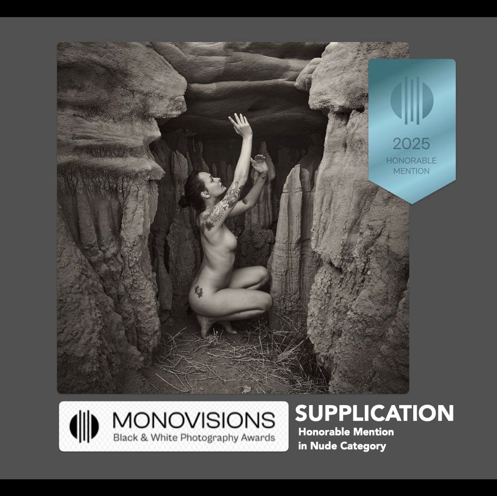 Model seen crouching and gesturing skyward in a niche in the rocks in the Valley of Dreams, Navajo Nation Land, New Mexico. Image is monochrome. 