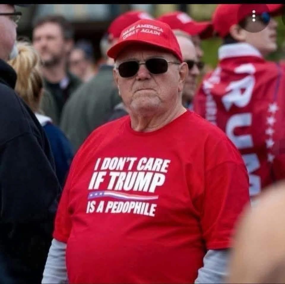 Trump supporter wearing a shirt that has “ I don’t care if Trump is a paedophile” printed on it .