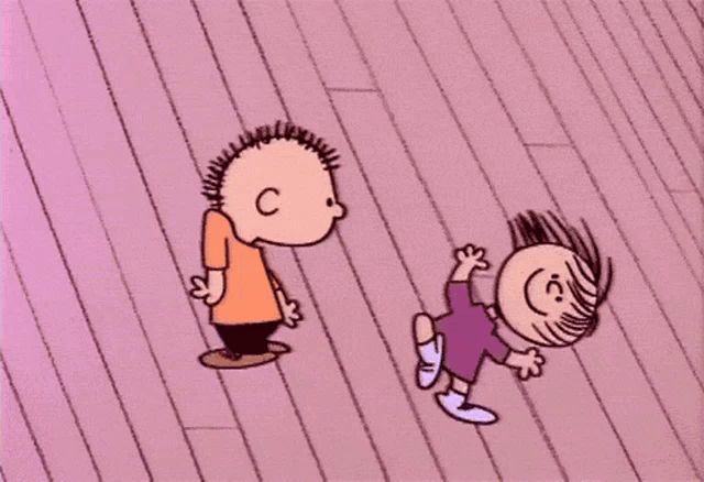 a boy and a girl are laying on a pink floor