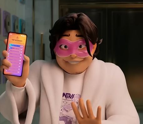 A frame from Kpop Demon Hunters of Bobby in a robe and spa face mask holding a phone. He is in the middle of talking and this frame makes it look like he's smiling with his front top teeth protruding in a decidedly unflattering way.