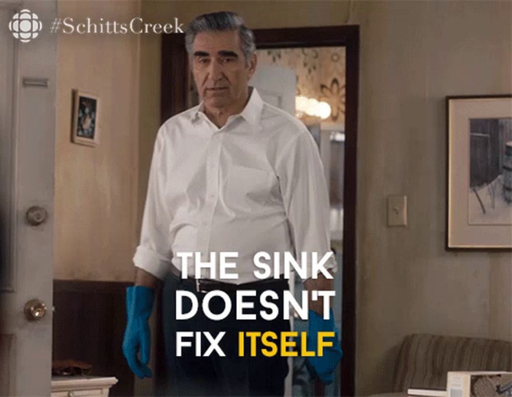 a man in a white shirt and blue gloves says the sink does n't fix itself in yellow letters