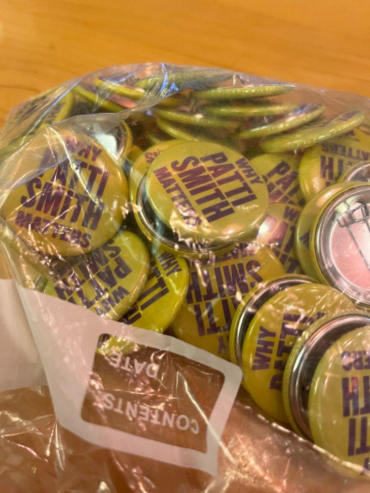 A ziplock bag full of why PATTI smith matters badges 