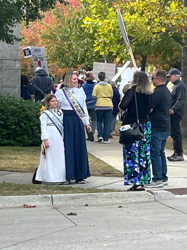 A mother and daughter dressed as suffragettes 