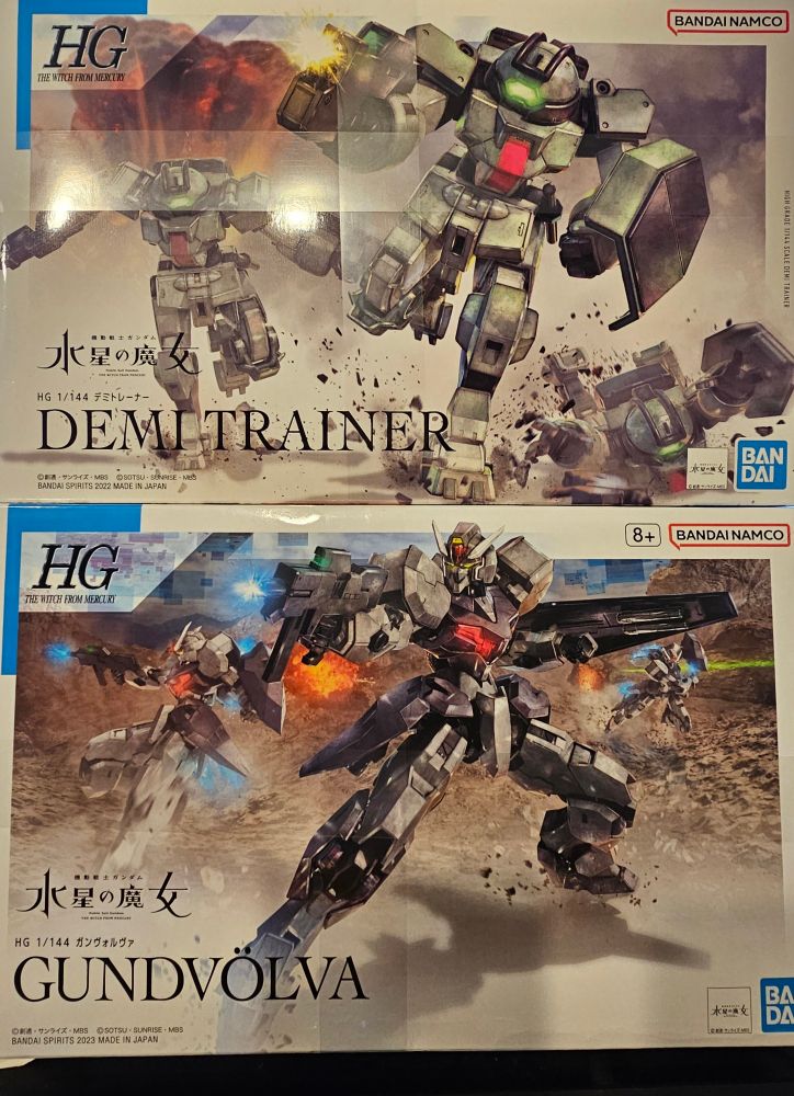 Picture of the front of boxes containing Gunpla models for the Demi Trainer and Gundvolva from Mobile Suit Gundam: The Witch From Mercury