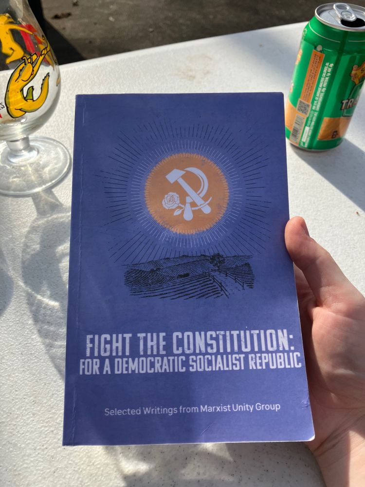 Fight the constitution: for a democratic socialist republic, selected writings from Marxist unity group book sitting on a picnic table outside