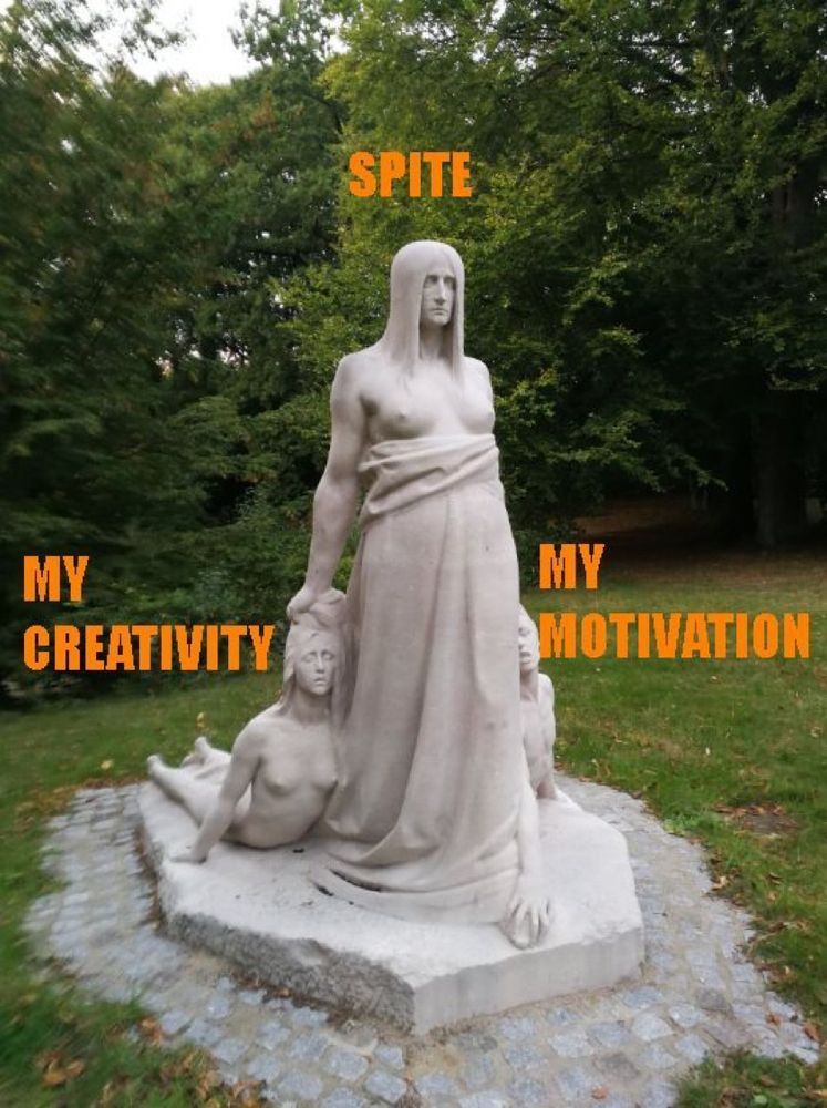 A sculpture of a bare-chested angry woman dragging two corpses behind her.  The woman is labeled "Spite" and the corpses are labeled "My Creativity" and "My Motivation"