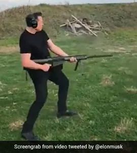 Elon Musk playiing tuff bro with assault rife & pointy-toe pimp boots. 