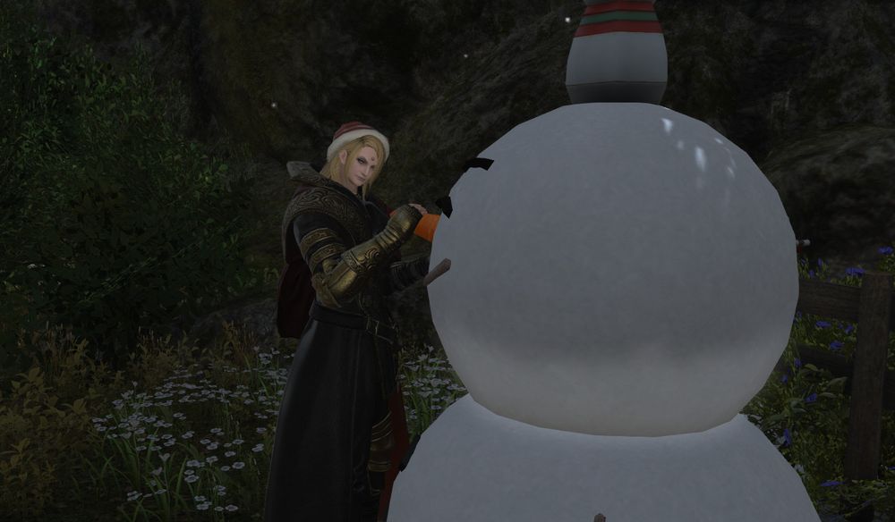 Zenos attaches the carrot nose to a snowman with great determination