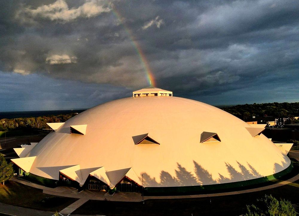 The Superior Dome in front of a rainbow