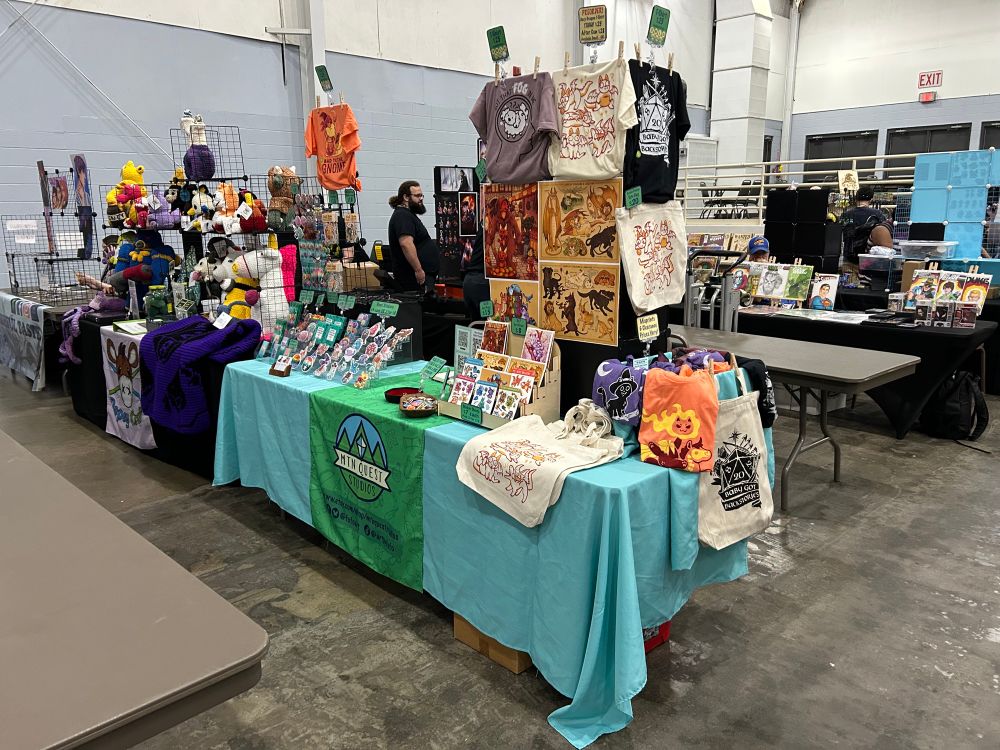 An artist alley set up for Mountain Quest Studios at FarleyCon. 