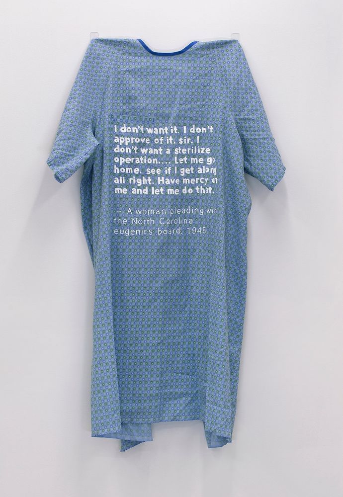 A blue worn hospital gown with white text painted on that says: "I don't want it. I don't approve of it, sir. I don't want a sterilize operation...Let me go home, see if I get along all right. Have mercy on me and let me do that." —a woman pleading with the North Carolina eugenics board, 1945

36"x30", 2019