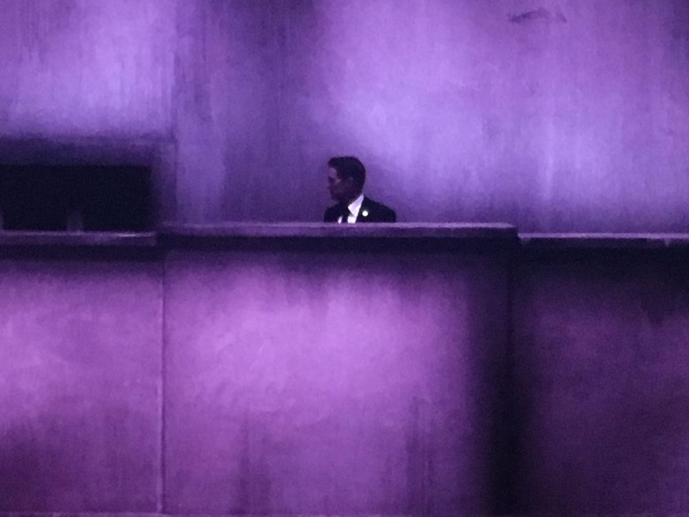 Dale Cooper (Twin Peaks The Return) standing on an eerie cement structure, bathed in purple light. 