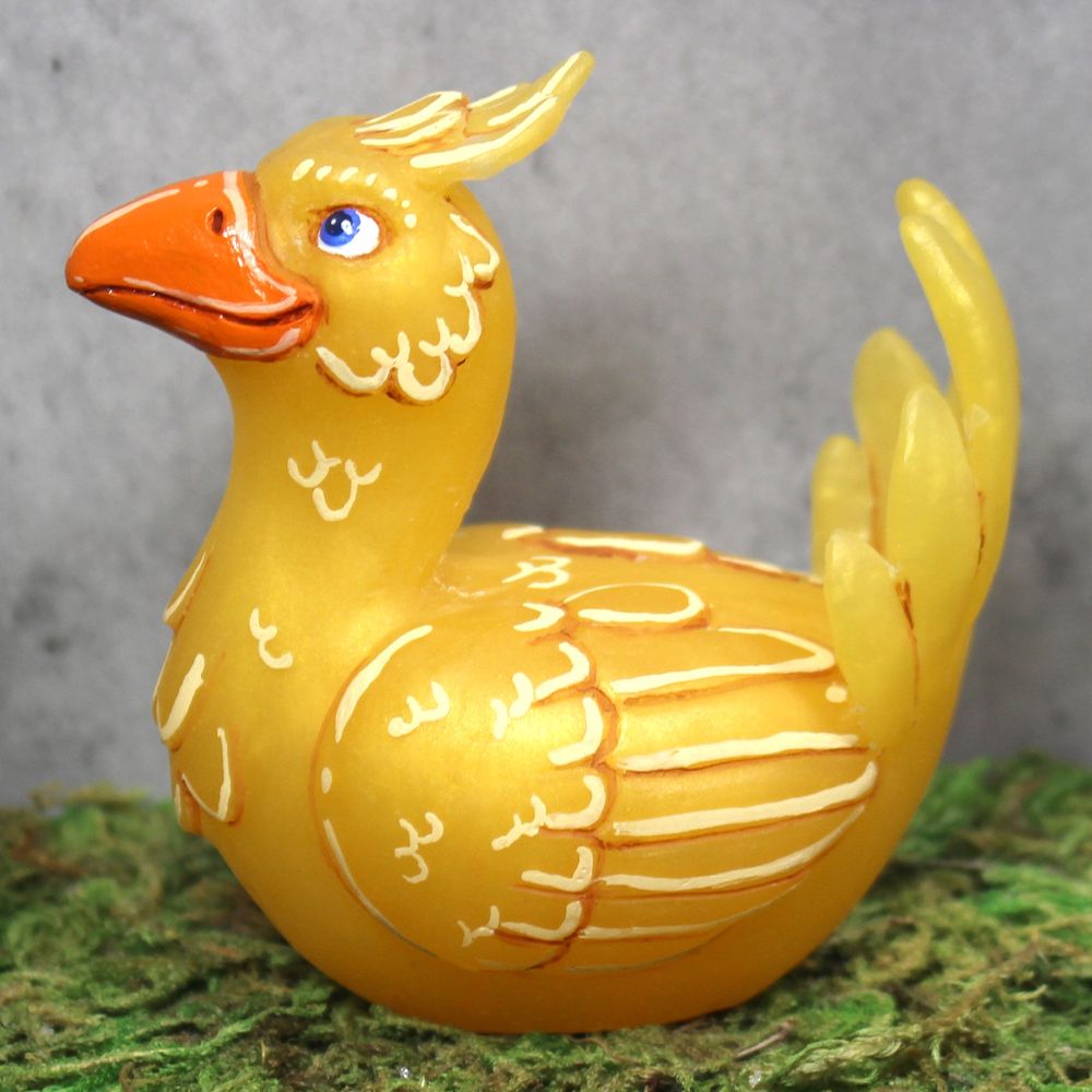 A yellow chocobo figure seated like a nesting chicken.
