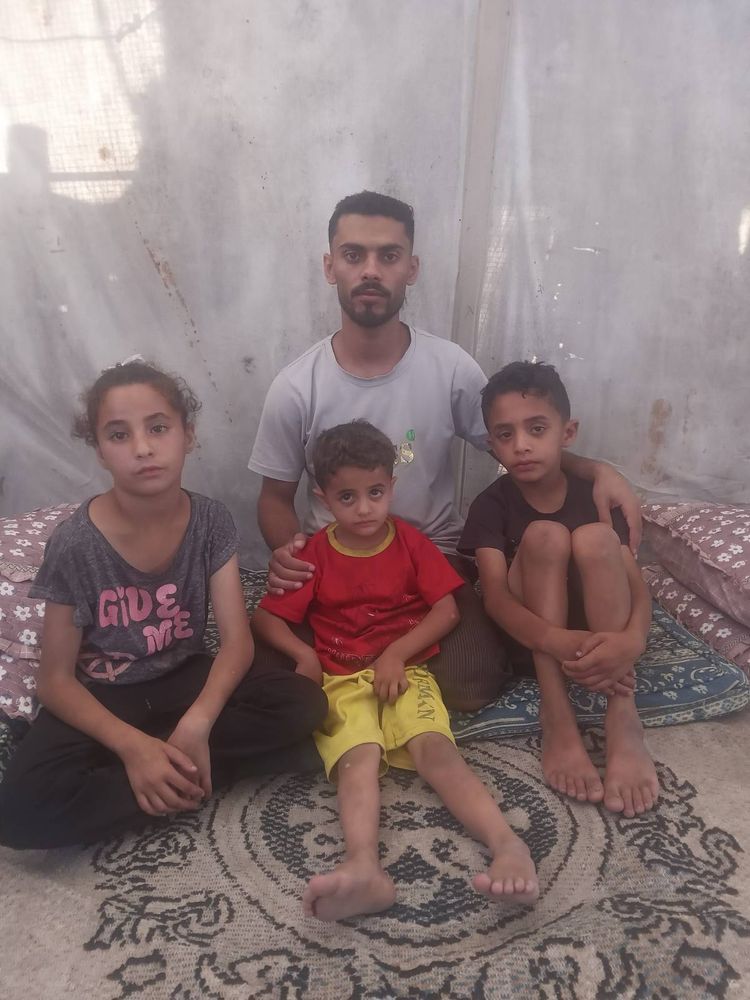 Ahmed sits in a tent with young Muhammad, Imad and Dahab. 